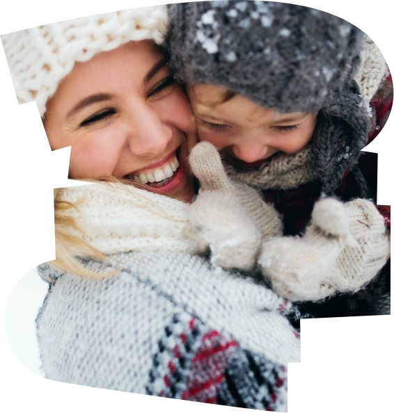 A woman and child wrapped up warm wearing hats and scarves