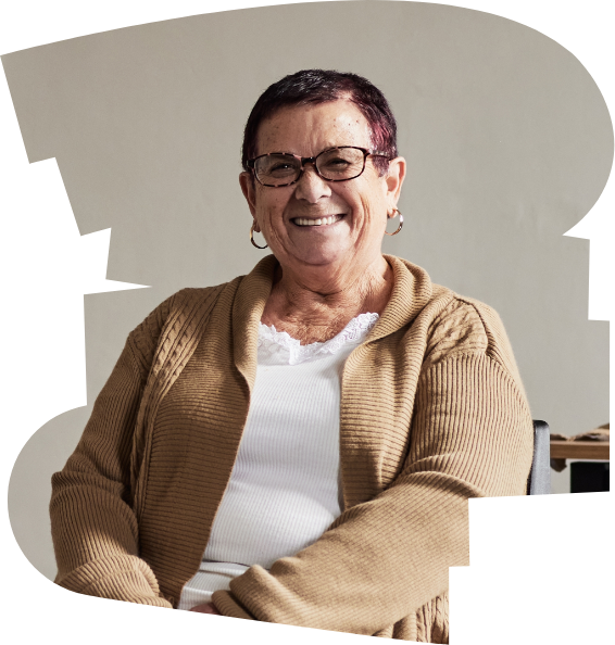 A woman sitting at a desk smiling